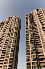 A couple of tall buildings sitting next to each other