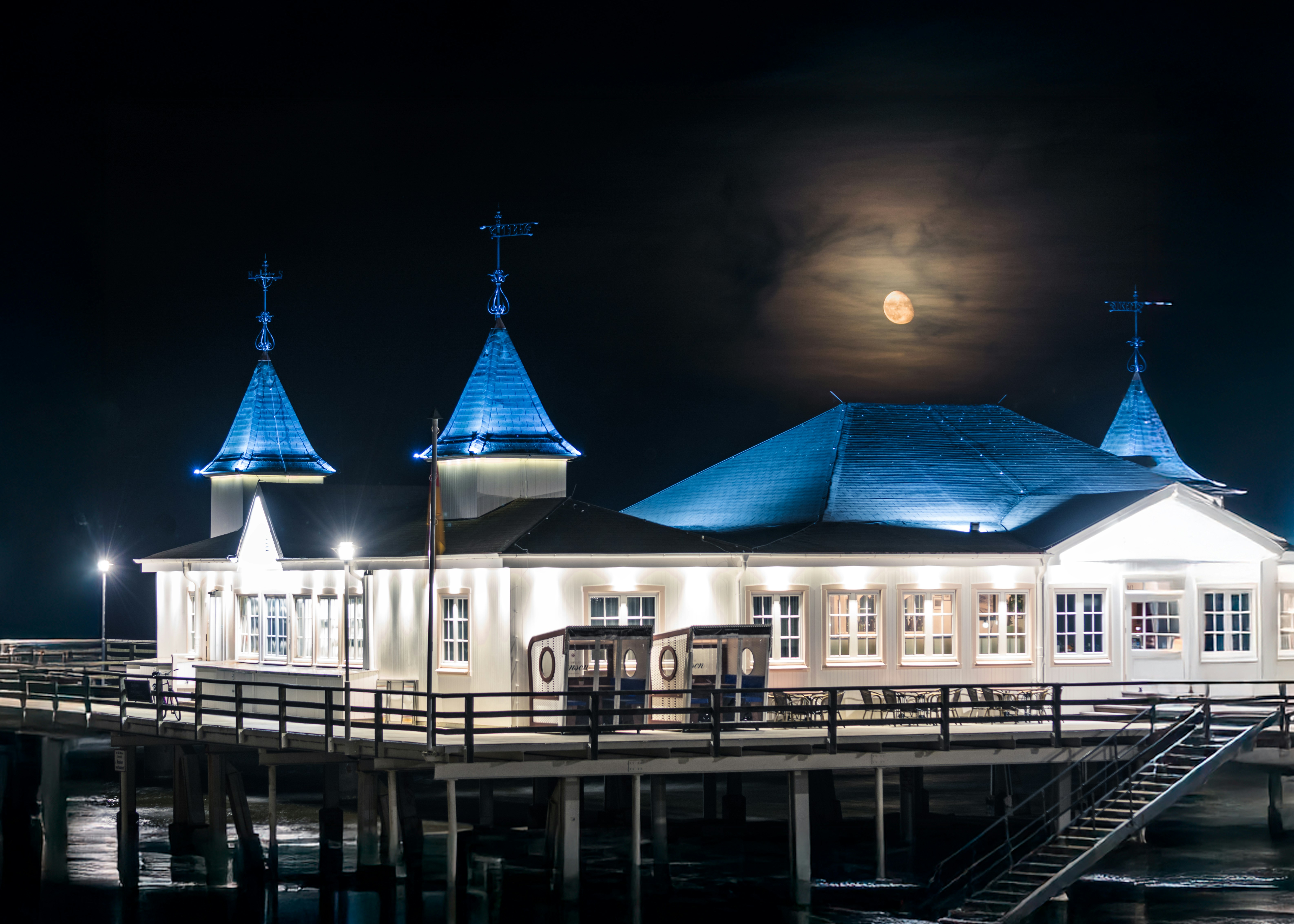 A pier with some lights on it at night