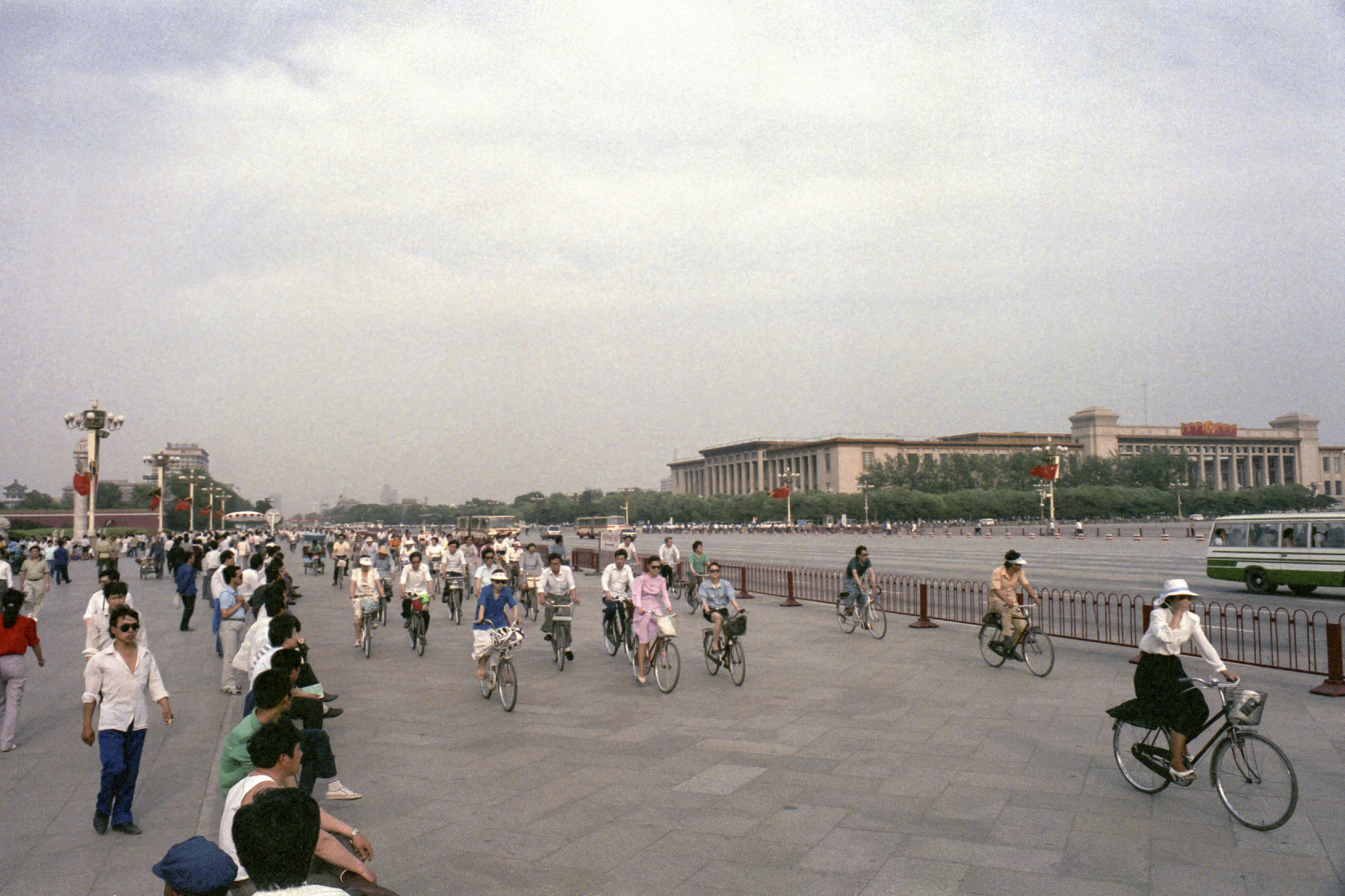 A group of people riding bikes down a street