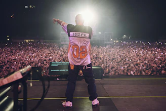A man standing on top of a stage in front of a crowd
