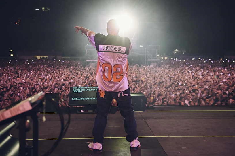 A man standing on top of a stage in front of a crowd