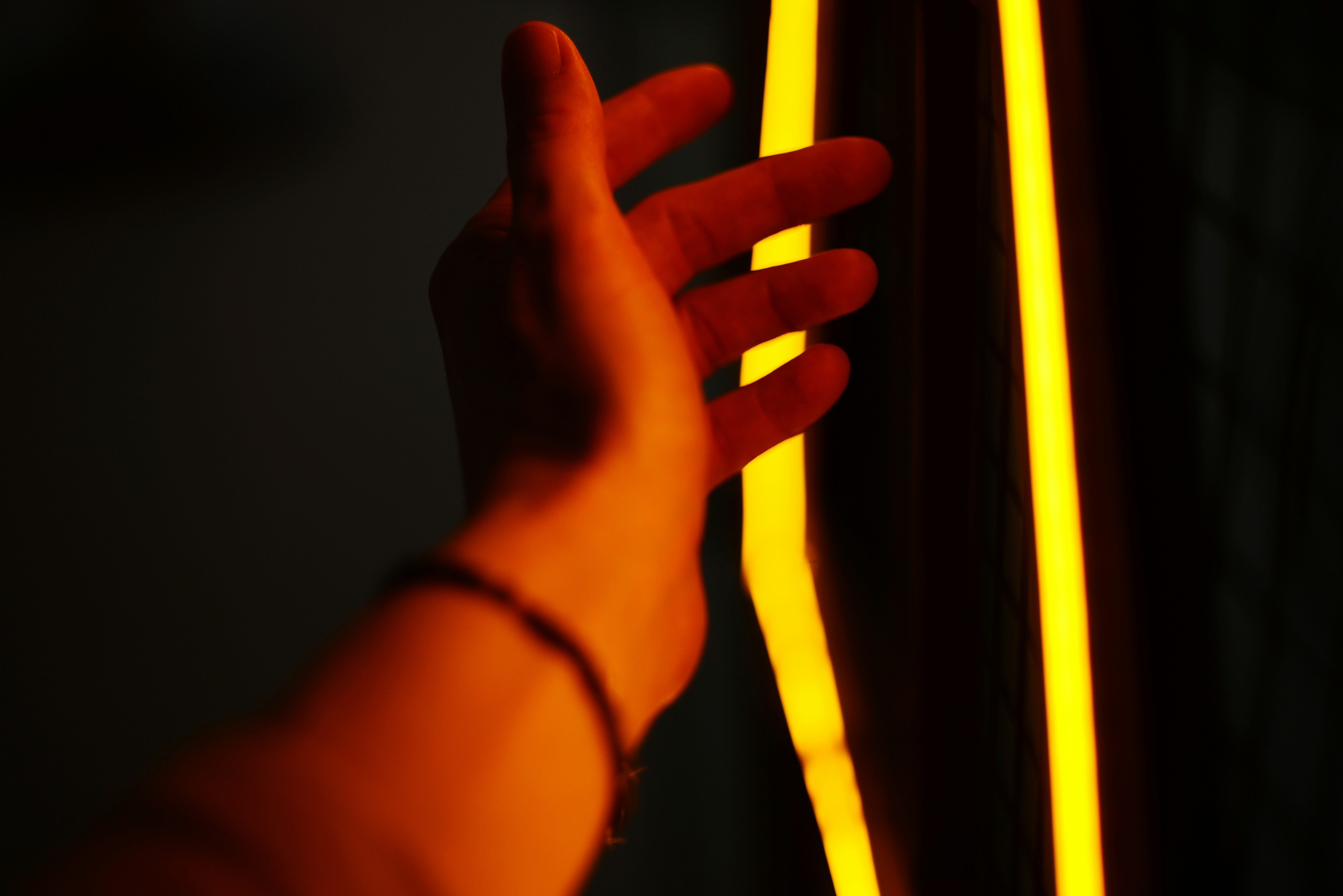 A person is holding a yellow light in their hand