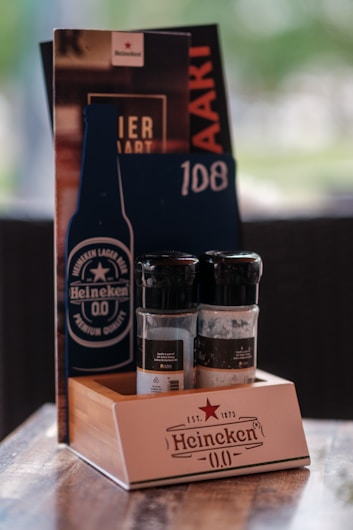 A wooden table topped with bottles of alcohol