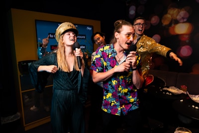 A group of people standing around each other in a room