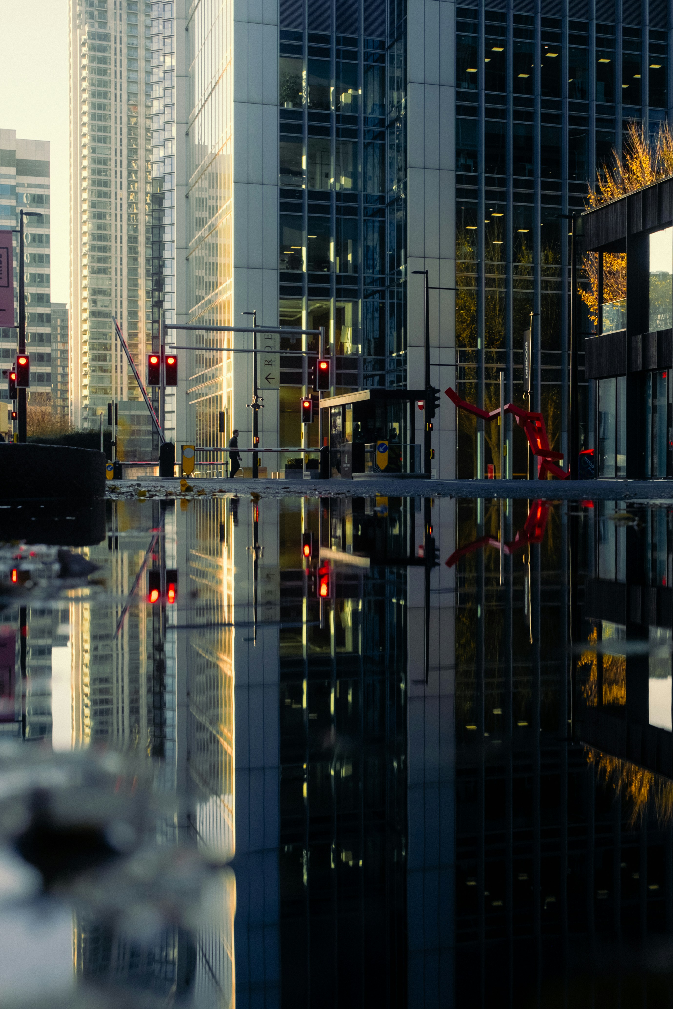 A reflection of a building in a body of water