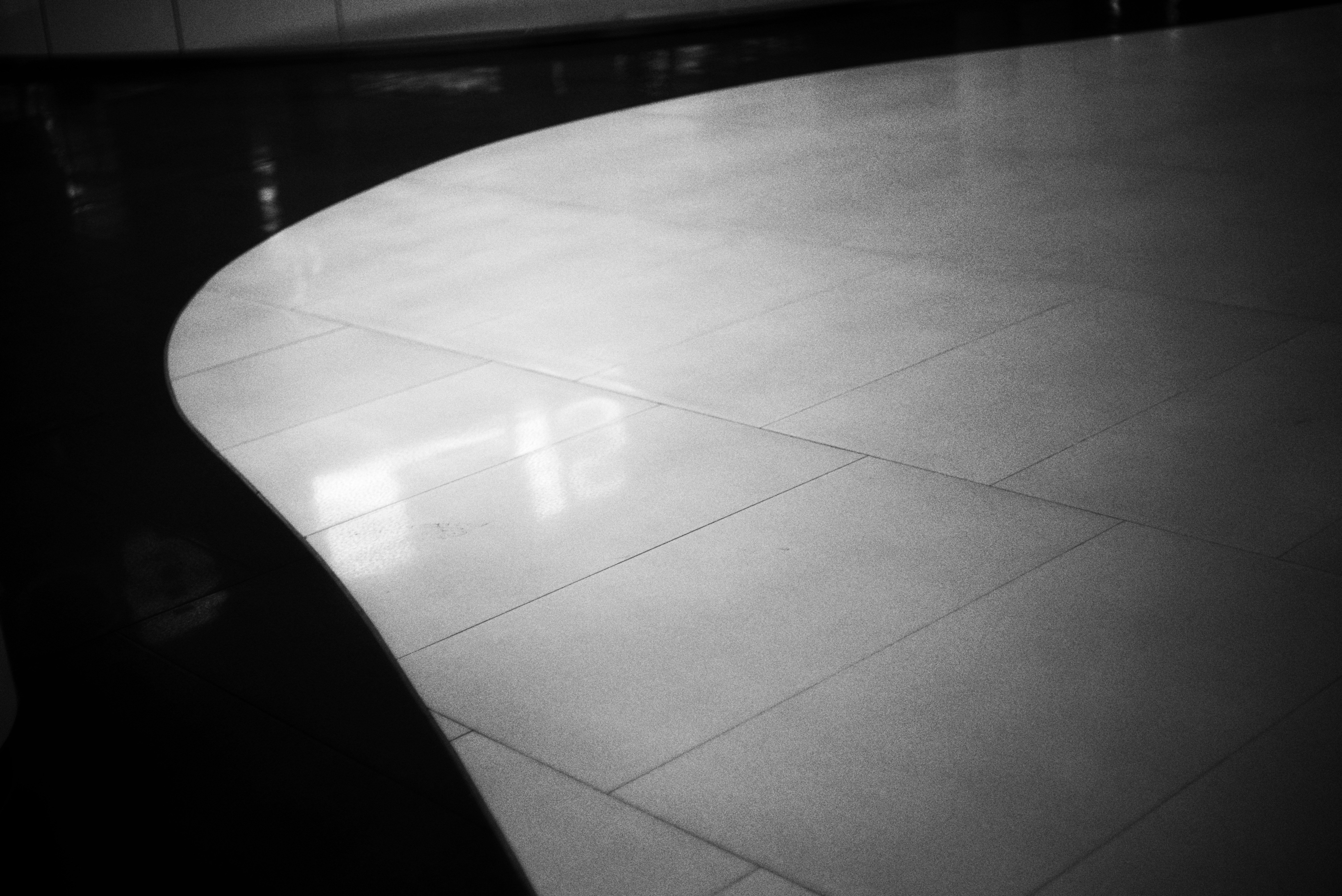 A black and white photo of a curved table