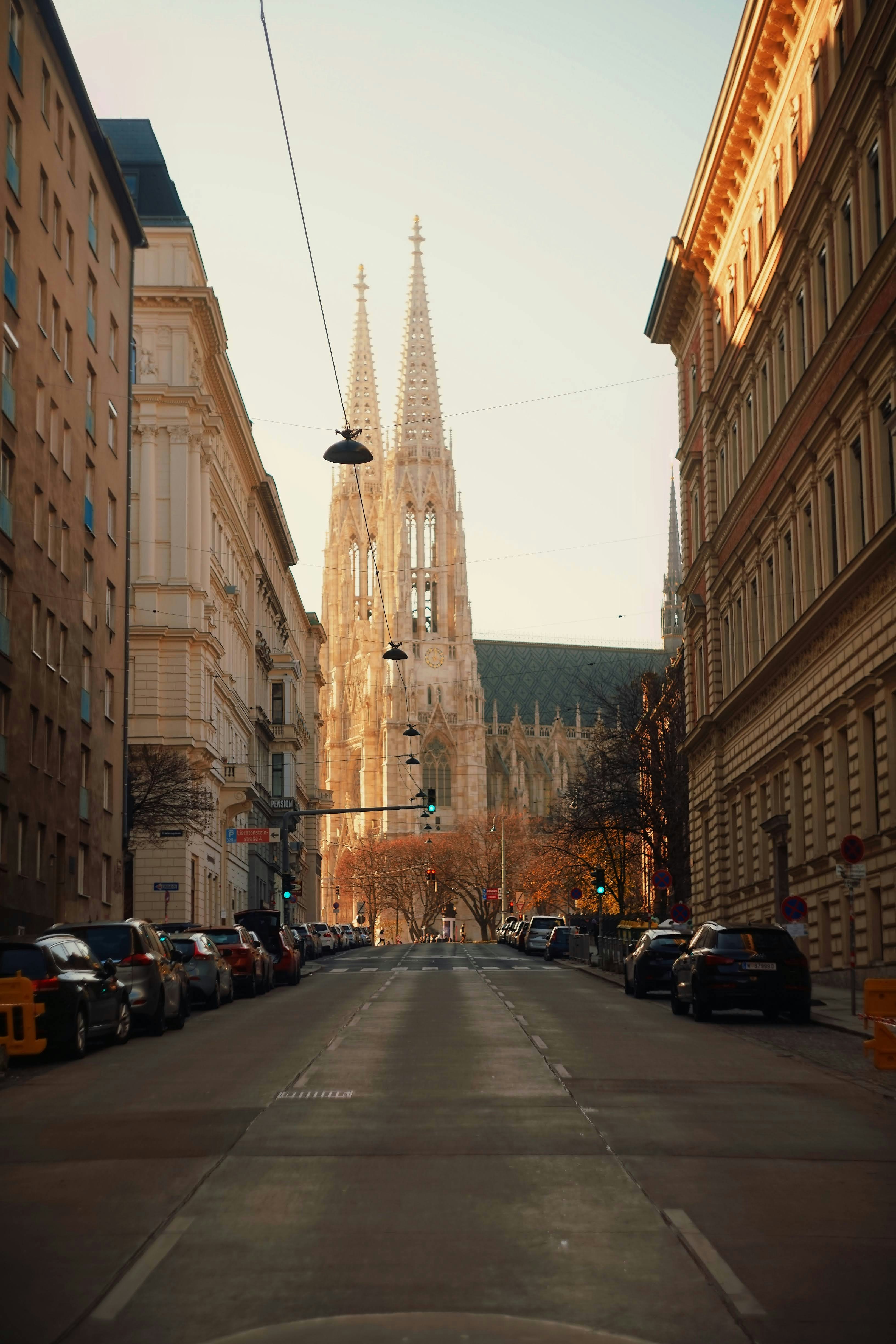 A city street with a church steeple in the background