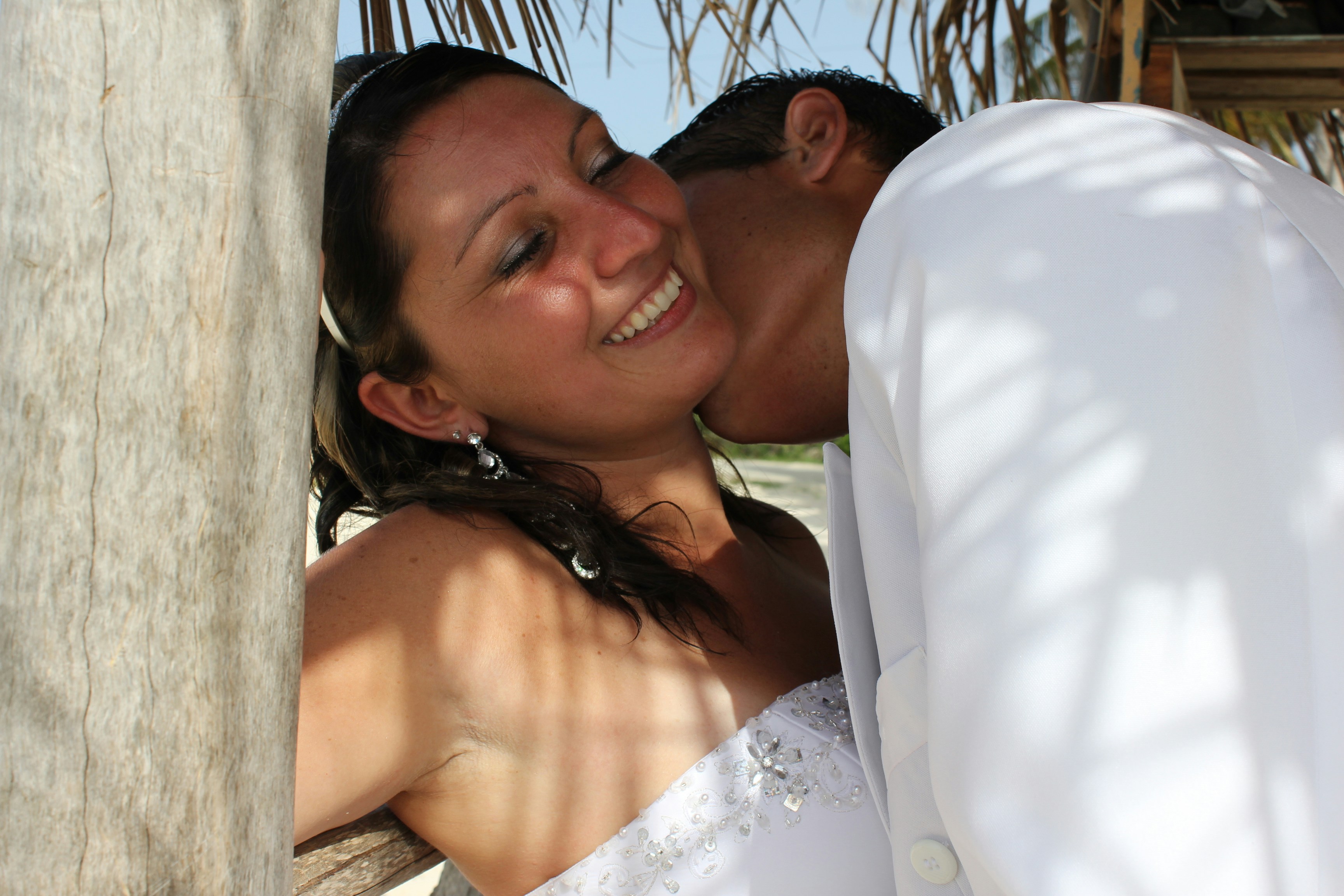 A man and a woman kissing on the beach