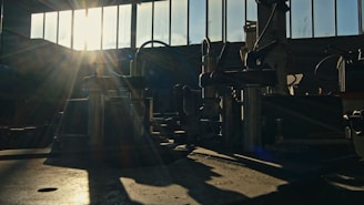 The sun is shining through the windows of a factory