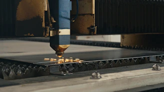 A machine that is cutting a piece of metal