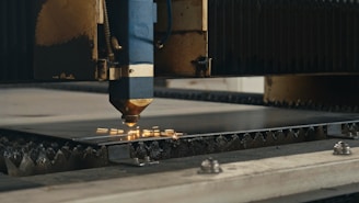 A machine that is cutting a piece of metal