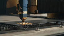 A machine that is cutting a piece of metal