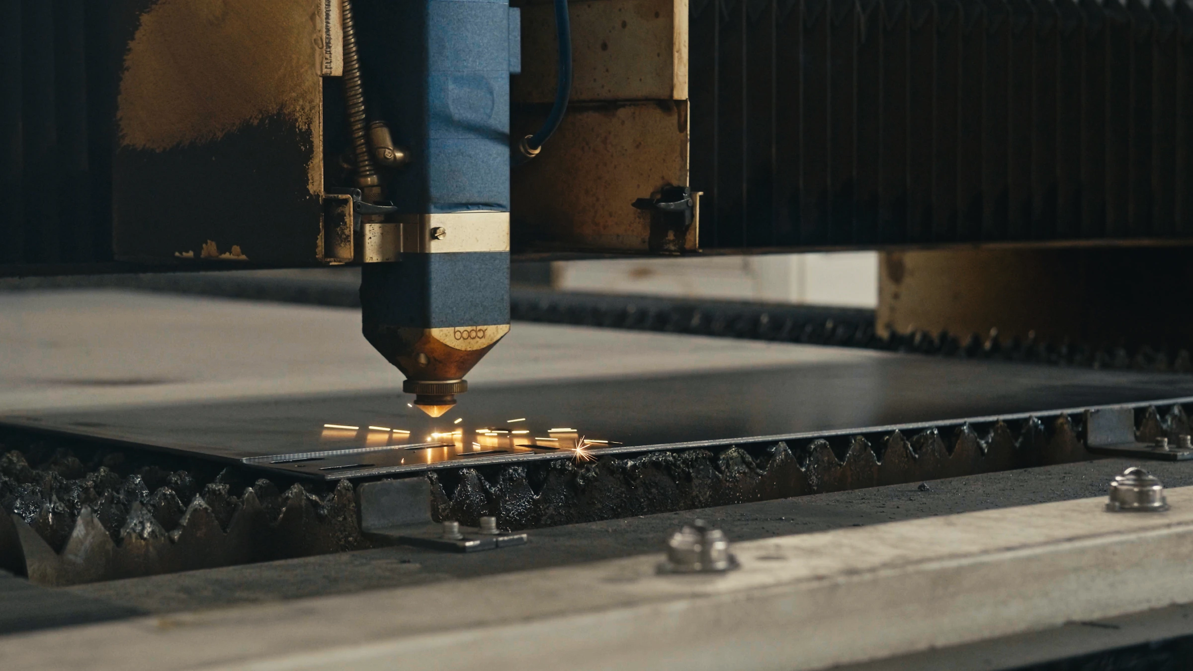 Laser cutting machine creating sparks while cutting metal