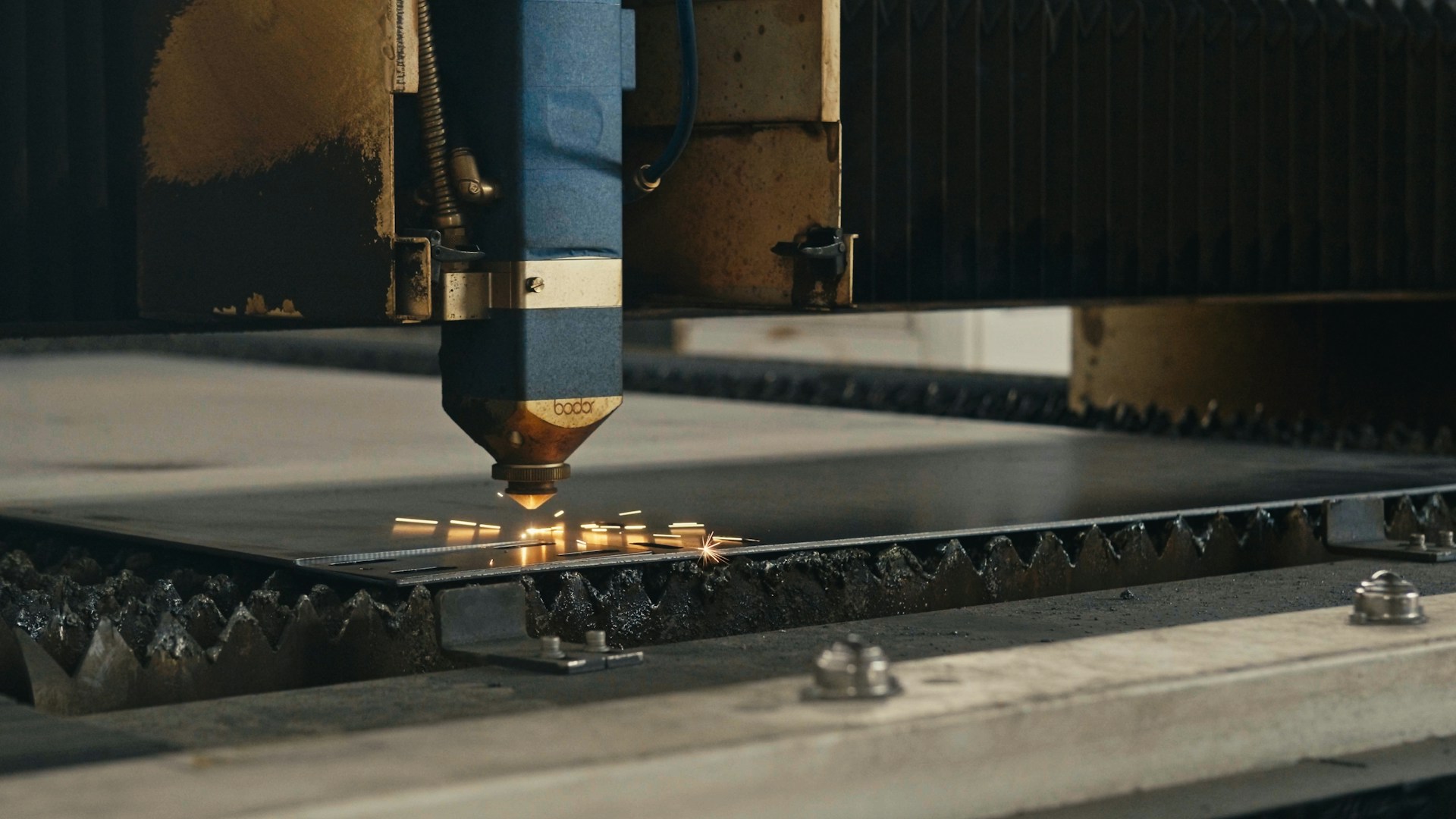 A machine that is cutting a piece of metal