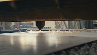A close up of a machine cutting a piece of metal