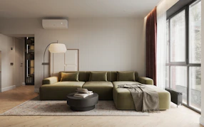 A living room with a large green couch