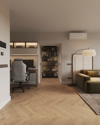 A living room with a couch a chair and a desk