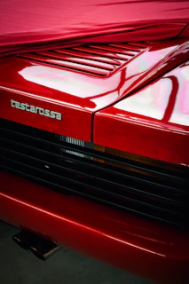 A close up of the hood of a red car