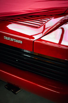 A close up of the hood of a red car