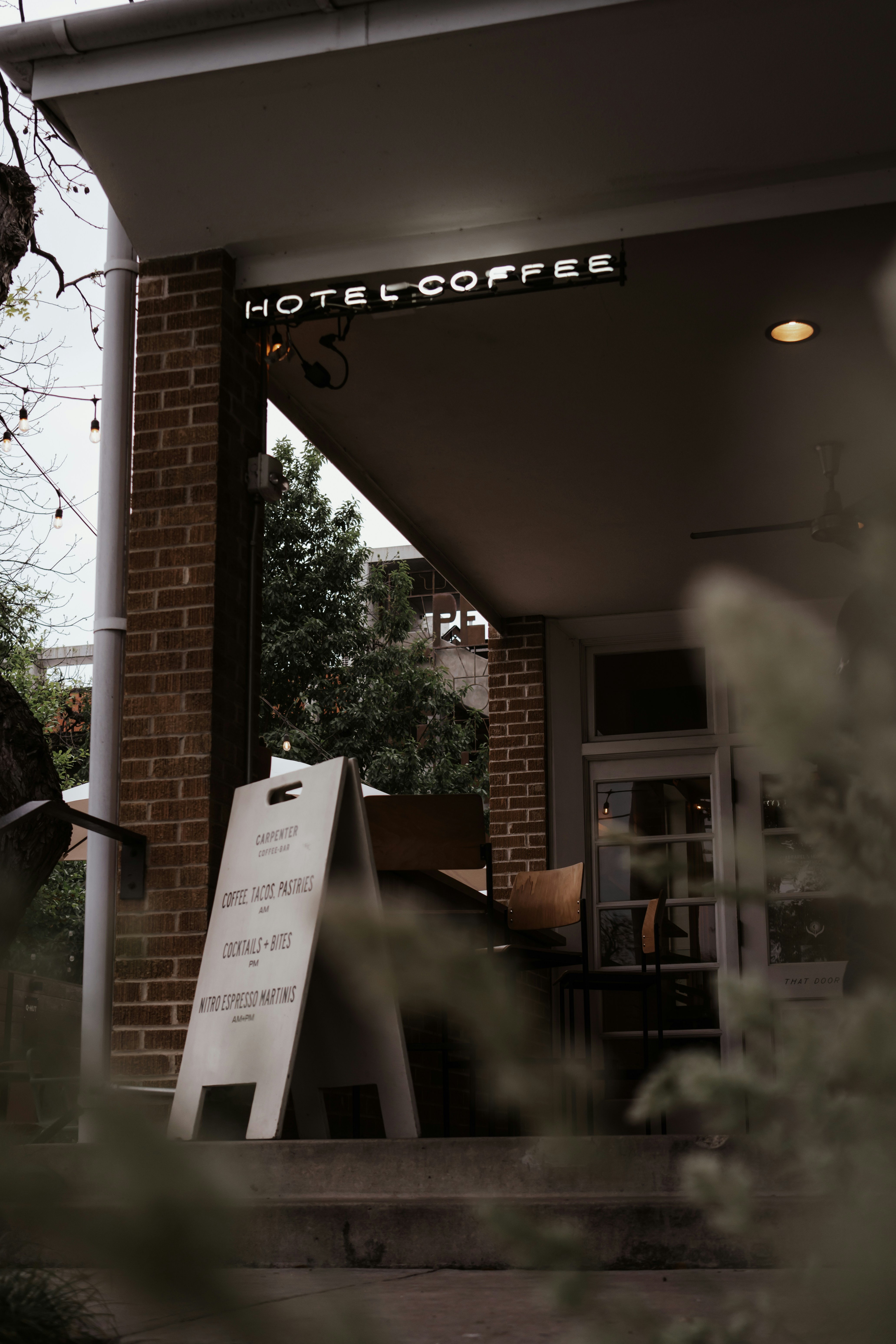 A man riding a skateboard down a sidewalk next to a tall building