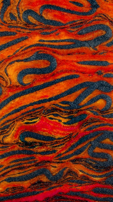 An abstract painting of orange, blue, and black swirls