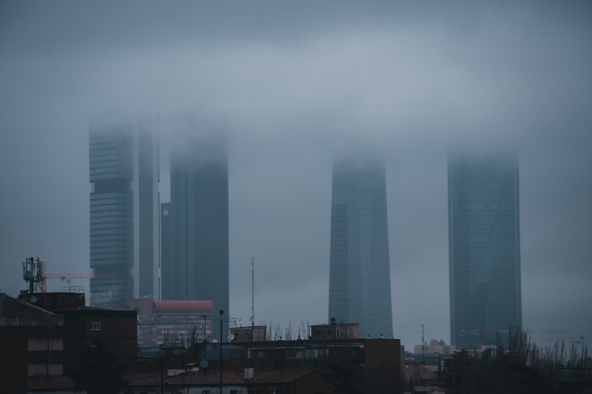 A foggy city with tall buildings in the background