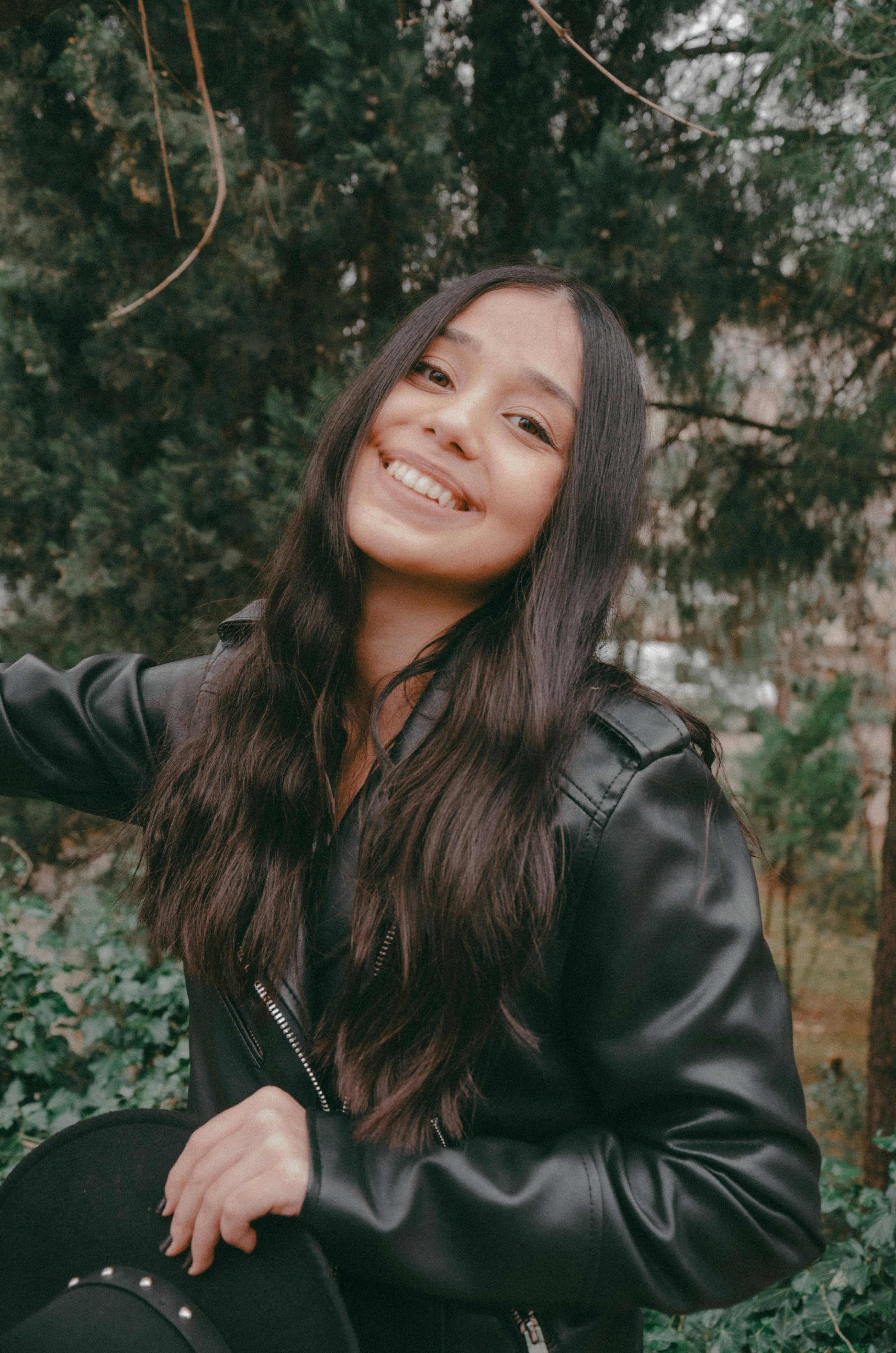 A woman in a black leather jacket is smiling photo – Free Portrait ...
