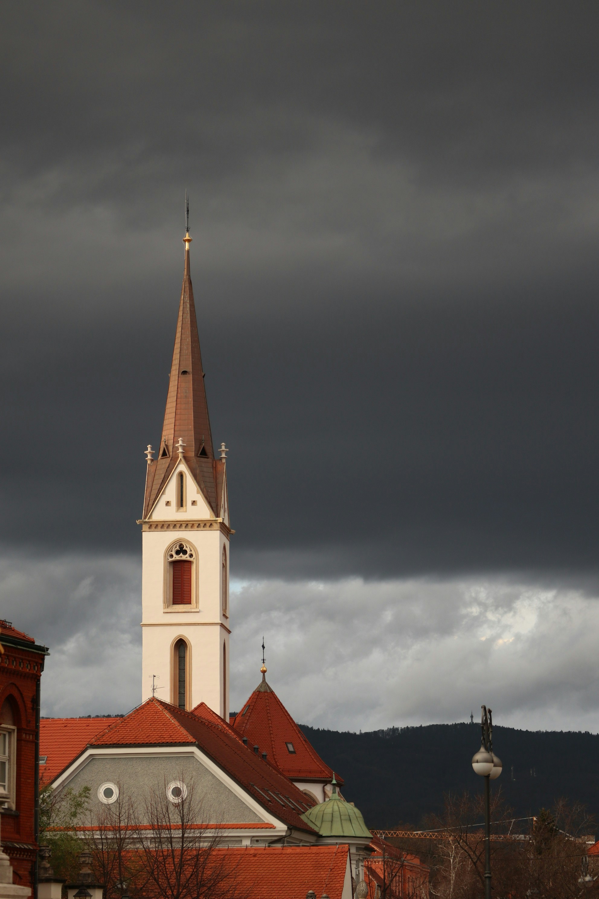 A church steeple with a cloudy sky in the background