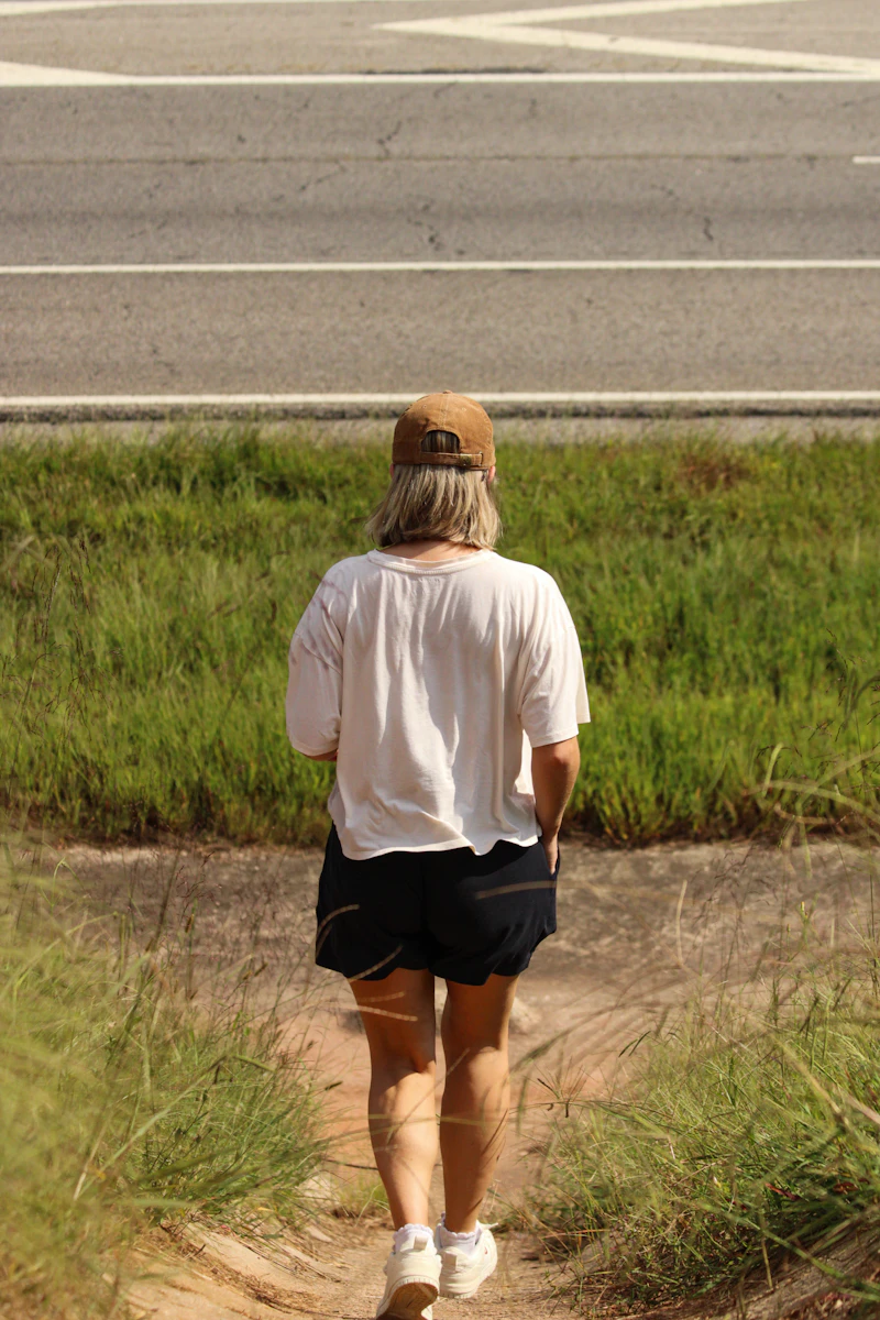 A woman walking briskly on a country path, starting her running journey