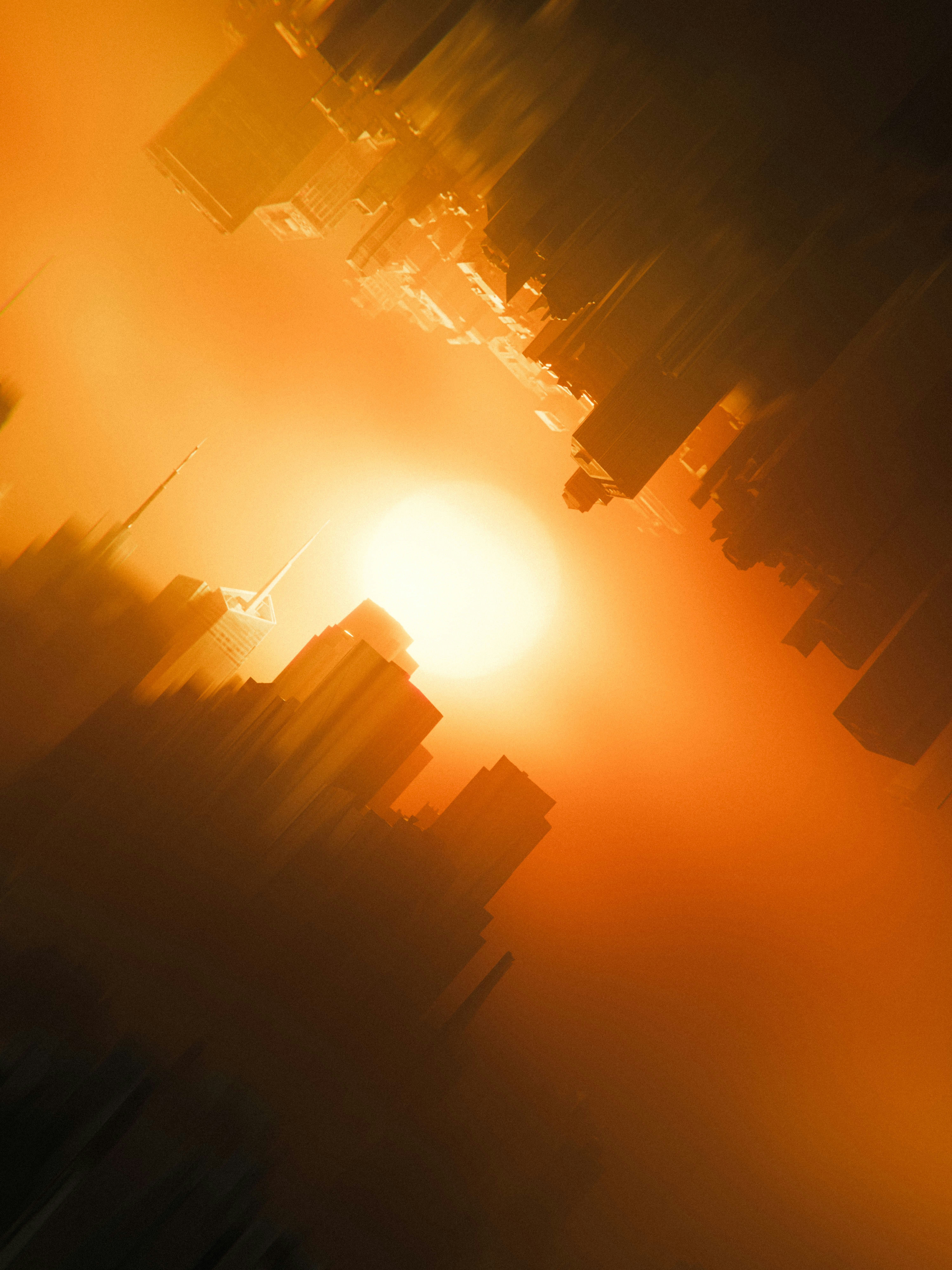 A blurry photo of the sun setting over a city