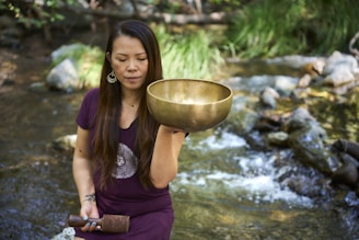 A woman in a purple dress holding a large bowl