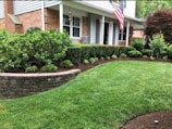 A house with a lawn and landscaping in front of it