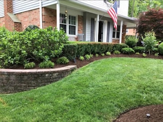 A house with a lawn and landscaping in front of it