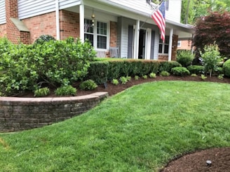 A house with a lawn and landscaping in front of it