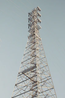 A very tall metal tower with a sky background
