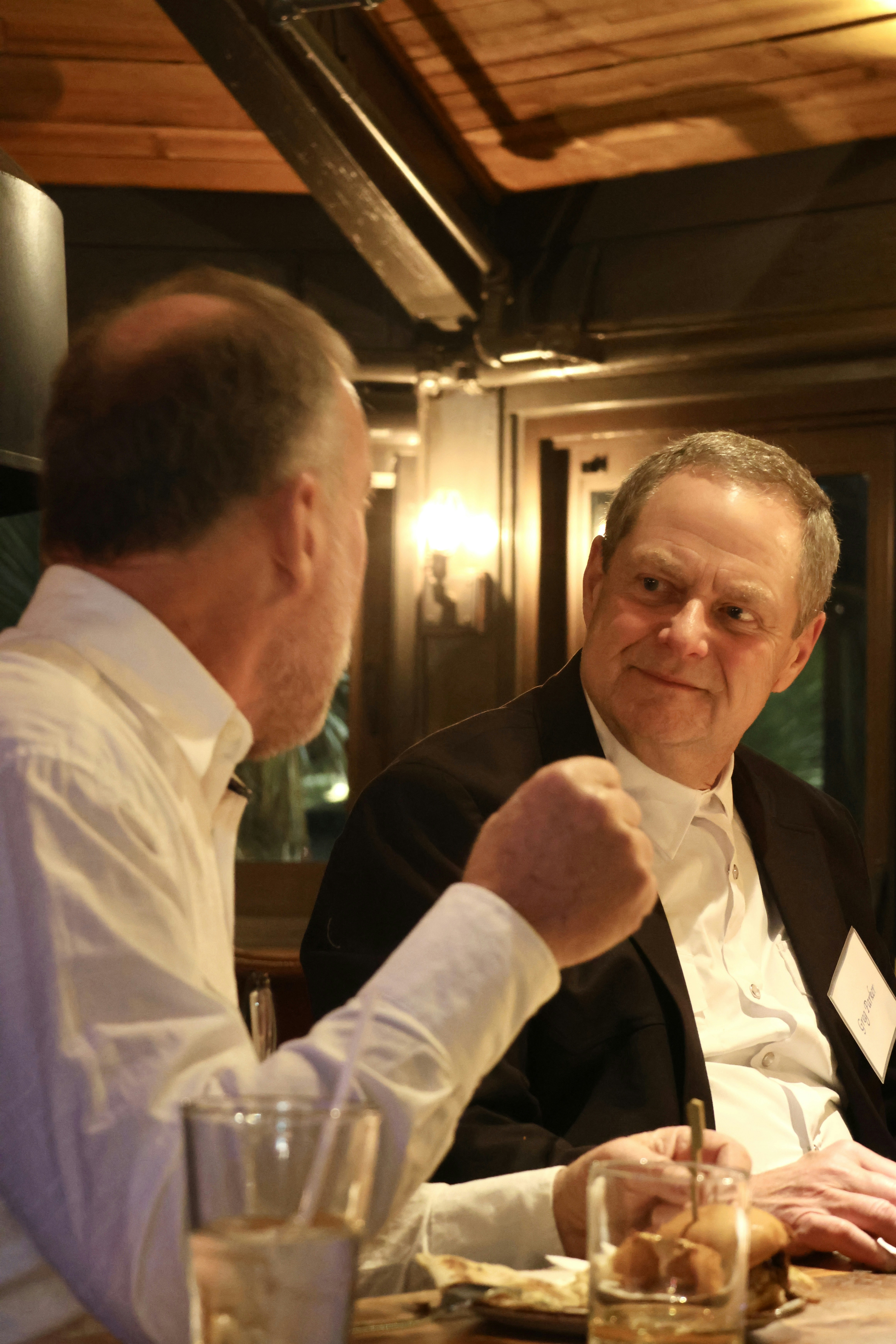 A group of men sitting at a table in a restaurant