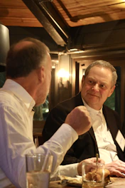 A group of men sitting at a table in a restaurant