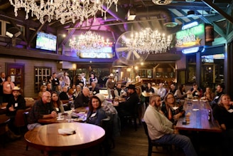 A group of people sitting around a table in a restaurant