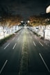 An empty street at night with no cars on it