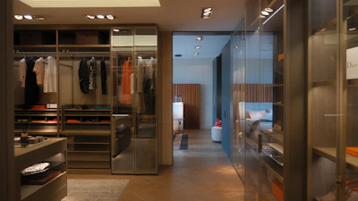 A walk in closet with a lot of clothes