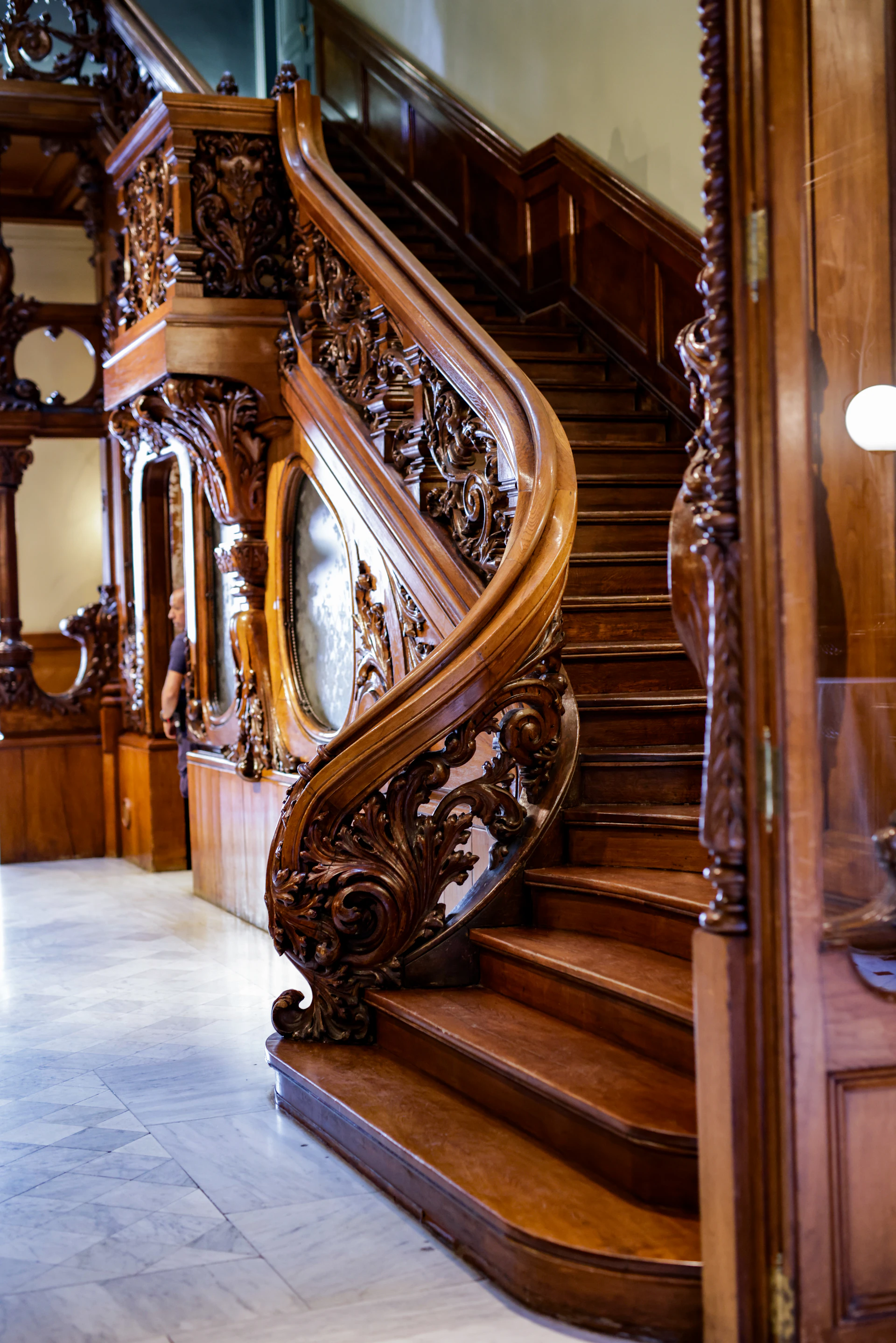 A large wooden staircase with a clock on the wall