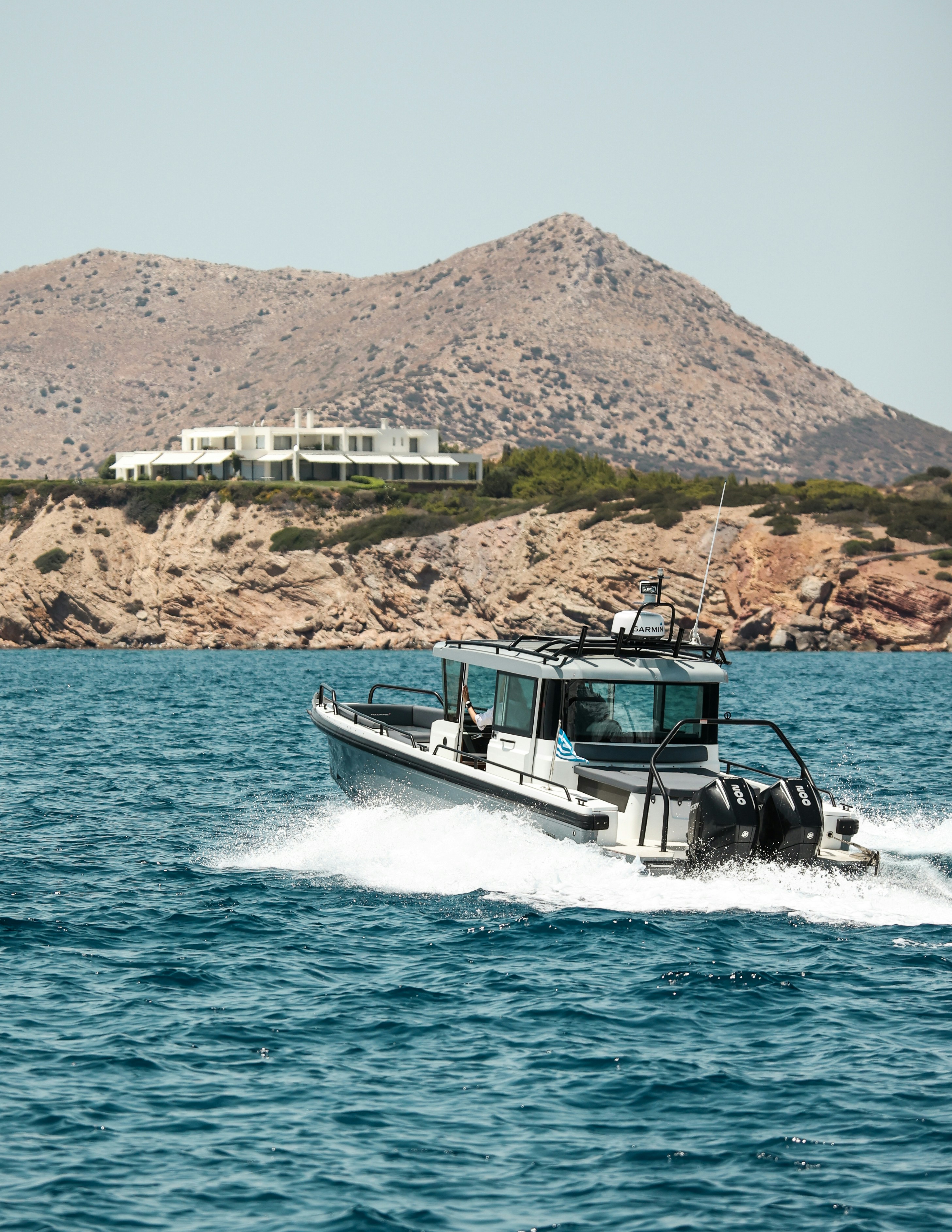 A small boat traveling across a large body of water