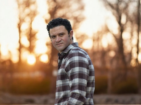 Responsible dad standing outdoors at sunset