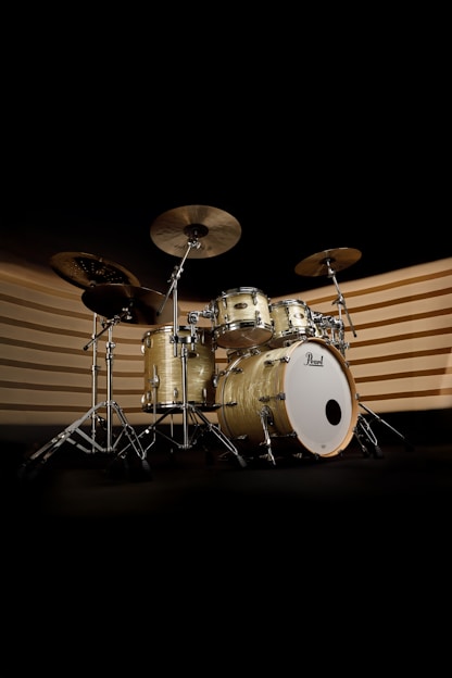 A drum set is shown in the dark