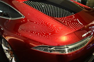 A red car parked in a parking lot
