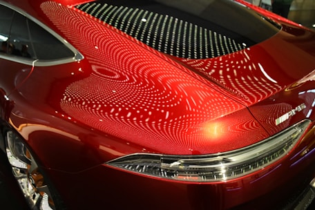 A red car parked in a parking lot