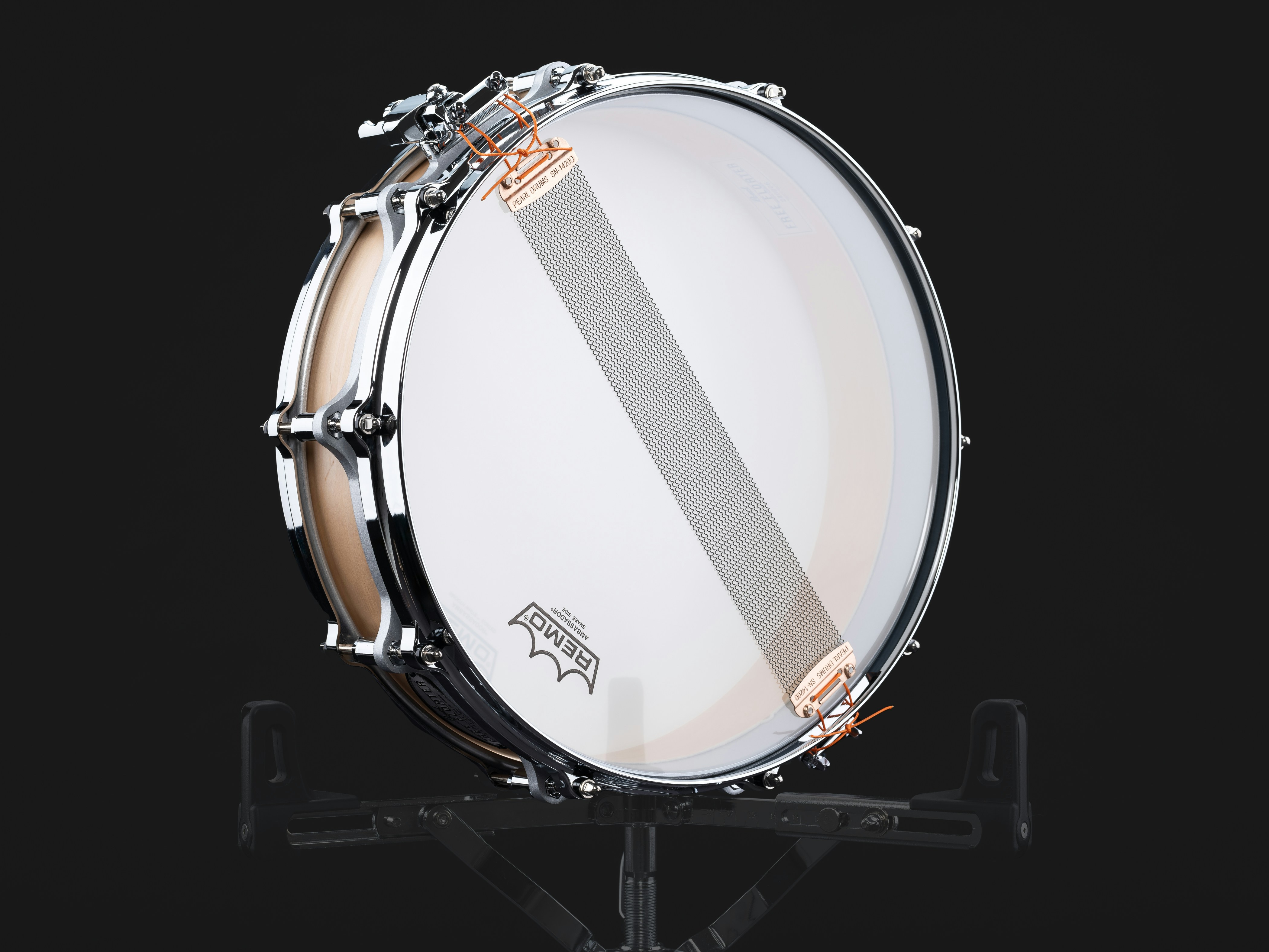 A white drum sitting on top of a metal stand