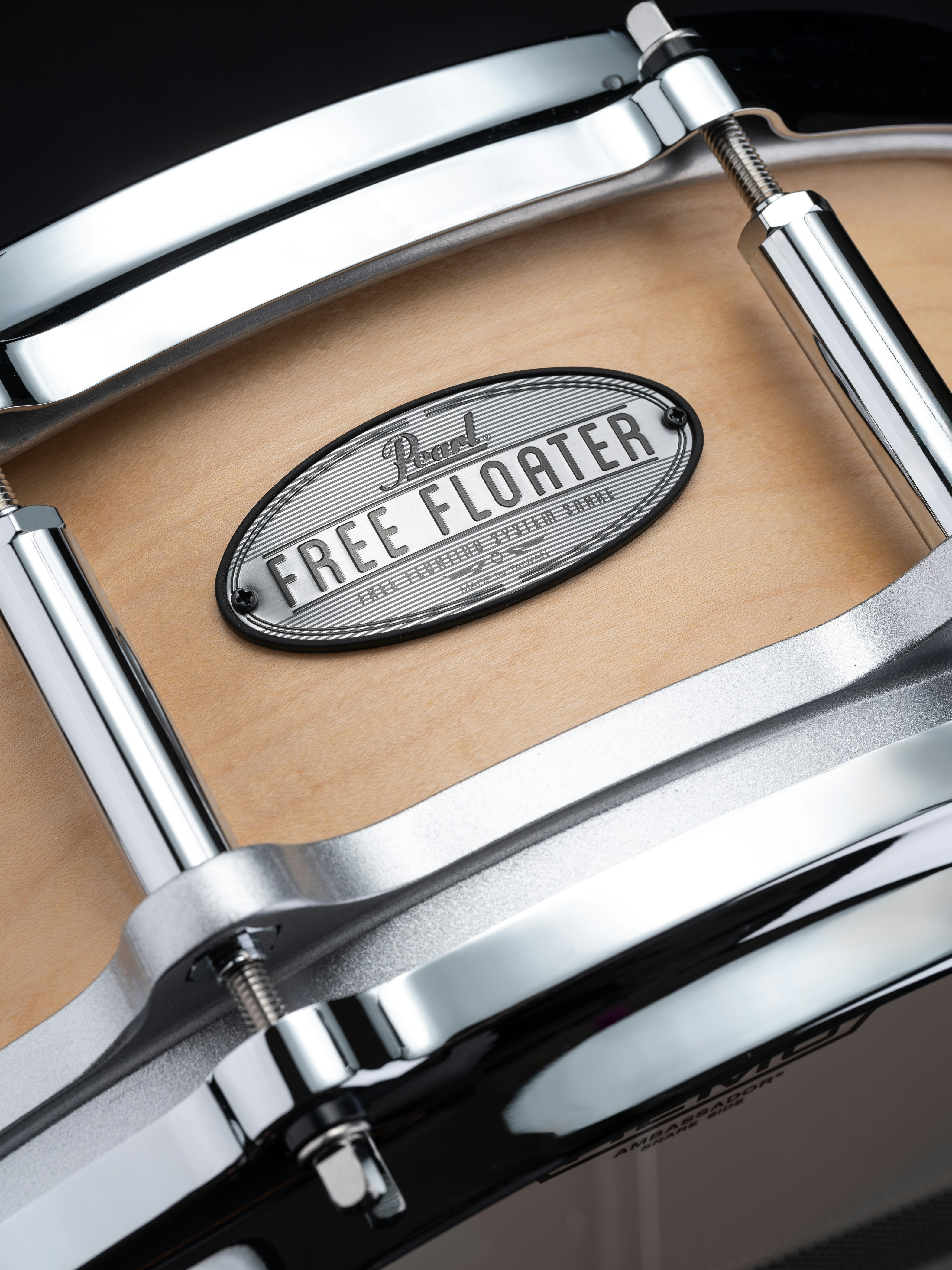 A close up of a drum on a black background