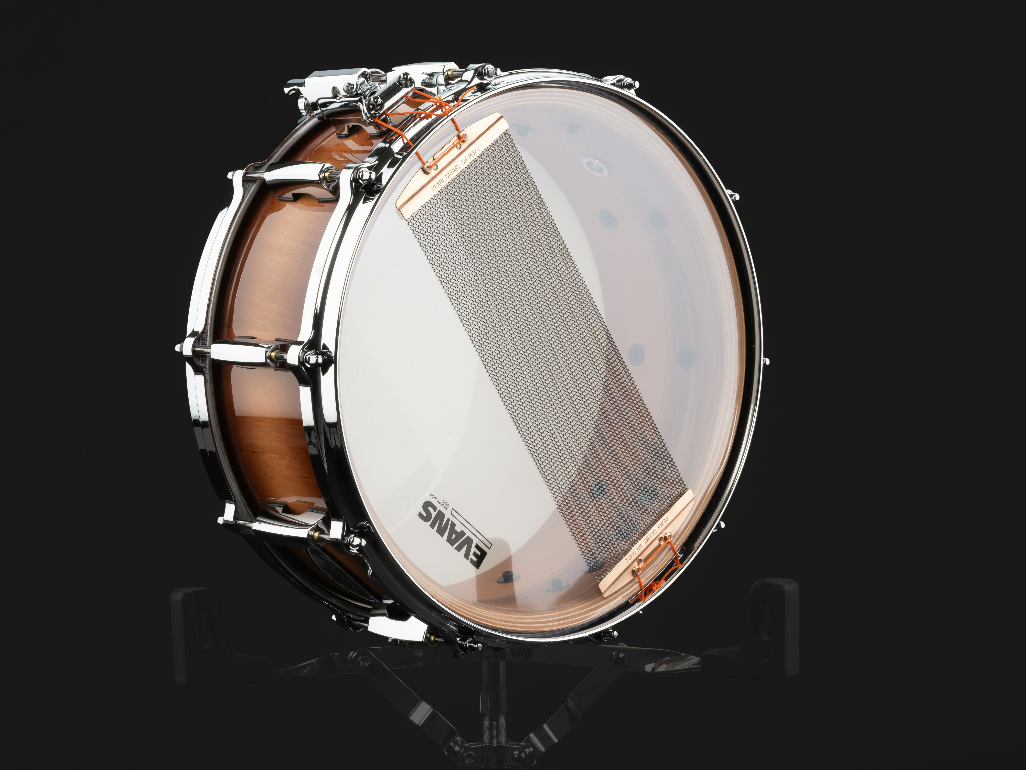 A close up of a drum on a black background