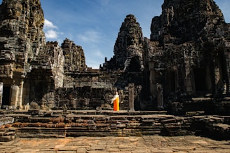 A person standing in front of a stone building